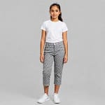 Pantalon fille à pois tendance et confortable, coupe ajustée, tissu doux, idéal pour tenues décontractées enfants.